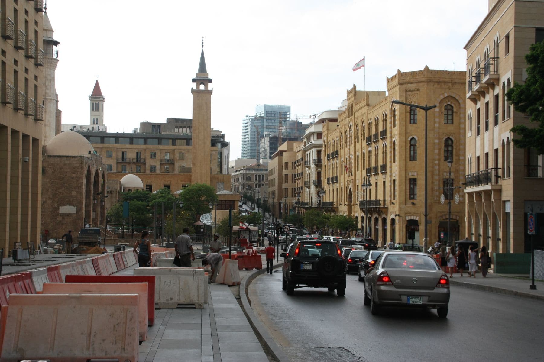 Cars driving along a street of restored sandstone buildings in downtown Beirut