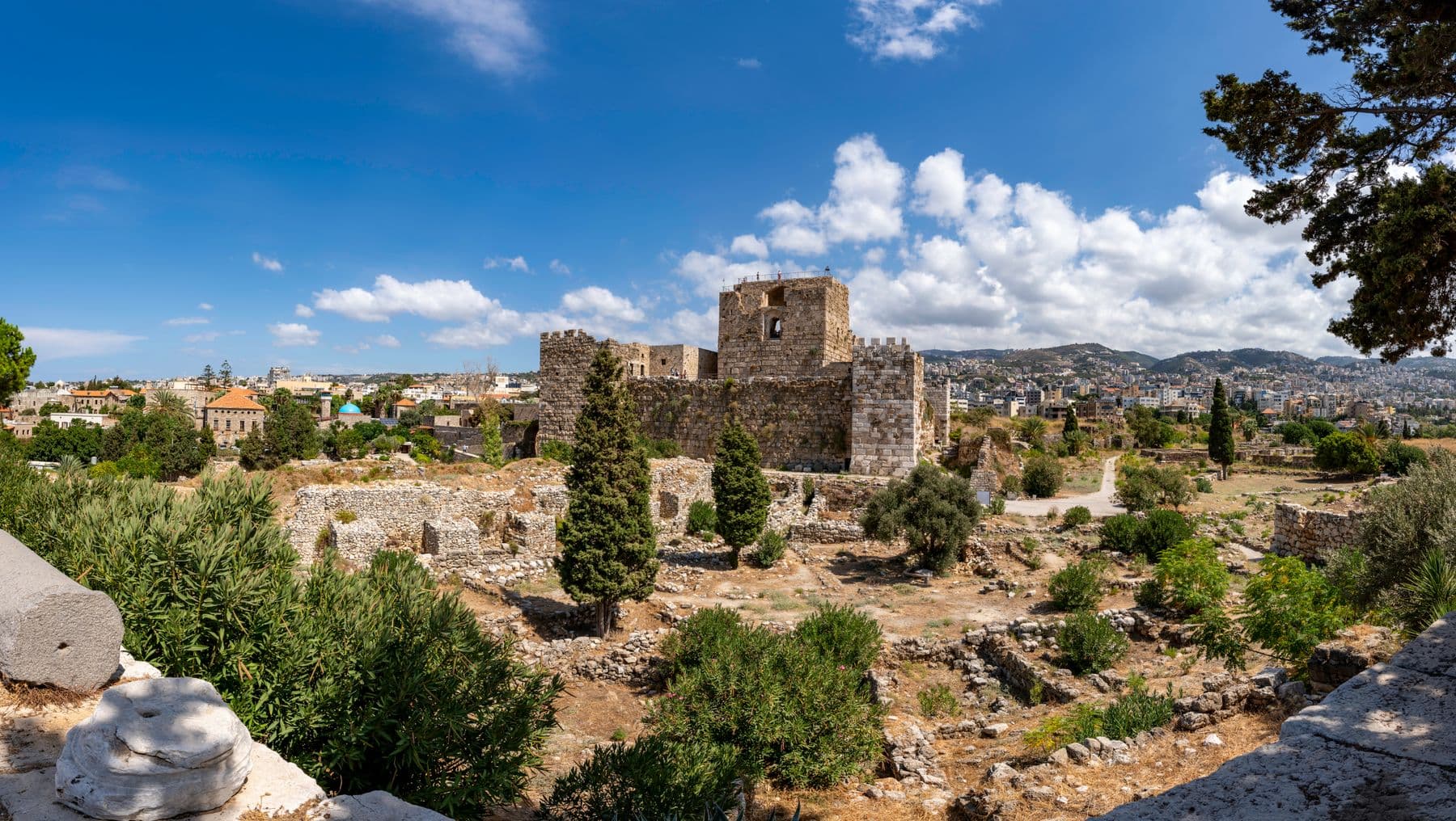 The Crusader castle and ancient ruins of Byblos under a blue sky